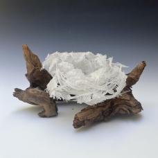 glass sculpture of nest on branches