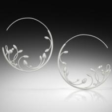 The Seeding Hoop Earrings were created in sterling silver. Fabrication techniques include forming and intricate soldering.