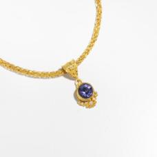 Iolite set in 22k gold with granulation. Pendant only.