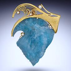 brooch with large trianglular blue stone