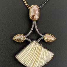 silver, gold, and ivory charm