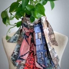 Many scarves layered on a mannequin with plant as head
