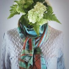 scarf wearing mannequin with plant as head