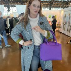 model holding purple felt bag