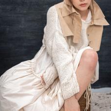 model wearing layered outfit in nuetral tones