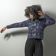 model with short jacket with large semi circle button accents