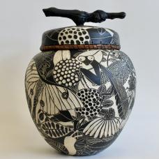 Bug Out Jar is a handbuilt ceramic jar made with stoneware clay that depicts insects and flowers found in Maryland.