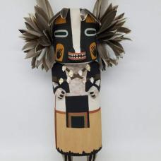 The badger Kachina is a symbol of strength  healing and protection. He is most commonly seen during the winter night dances. The badger kachina is carved from aged dried cottonwood root  painted with all natural mineral earth paints that I hand collect and process myself. Duck feathers  quail feathers and shells are used to complete the badger kachina.
