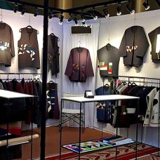 Booth with sweaters displayed on the wall