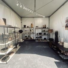 Booth set up shown with shelving units around the outside