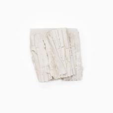 Porcelain sheets are folded and compressed  then packed with white clay between the layers. A light wax accent softens the surface and seals the fragile edges  preserving the fine textures. The piece reads like a small bundle of pages or strata—a quiet study in touch  fragility  and time.