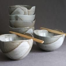 Wheel-thrown stoneware bowls  with hand cut wavy rims designed to hold a pair of chopsticks. Large enough for a meal  fits in your hand.