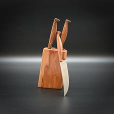 Set of four steak knives  with carbon steel blades and applewood grips  mounted in an applewood block. The assymetrical rivets and slender grips draw inspiration from artifaces in the London Museum's late medieval tableware collection.