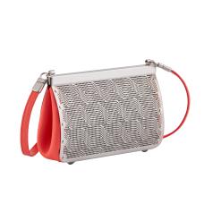 The ribbon clutch is hand fabricated in etched stainless steel. Has leather gussets  a detachable leather strap and a magnetic closure.