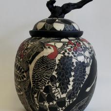 Picidae is a handbuilt ceramic pot made from stoneware clay, depicts four different kinds of woodpeckers that are found in Maryland.