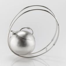 Sterling silver teapot. The piece rocks back and forth on the elliptical handles when put into motion.