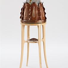 This presentation cabinet has 8 sculpted walnut leaves that all open in unison to reveal a glass dome that rotates to find doors that access the interior. It features delicate carving  piercing  and inlays of silver  mother of pearl  and abalone. Inspired by succulent plants.