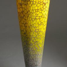 This large wood vessel is finished in a bright chrome yellow that looks like citrus.