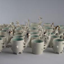 Porcelain espresso cups created using a combination of wheel throwing and hand building techniques.