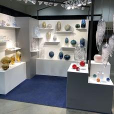 Booth with glass art on shelves