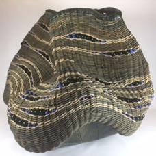 A mossy blue stoneware base featuring leaf impressions is woven with smoked and hand dyed reed and twisted seagrass cord. Glass beads embellish and the rim is supple leather.