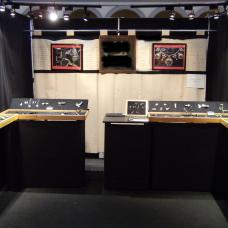 10 x 10 display booth with professional display cases  drapery and lighting.