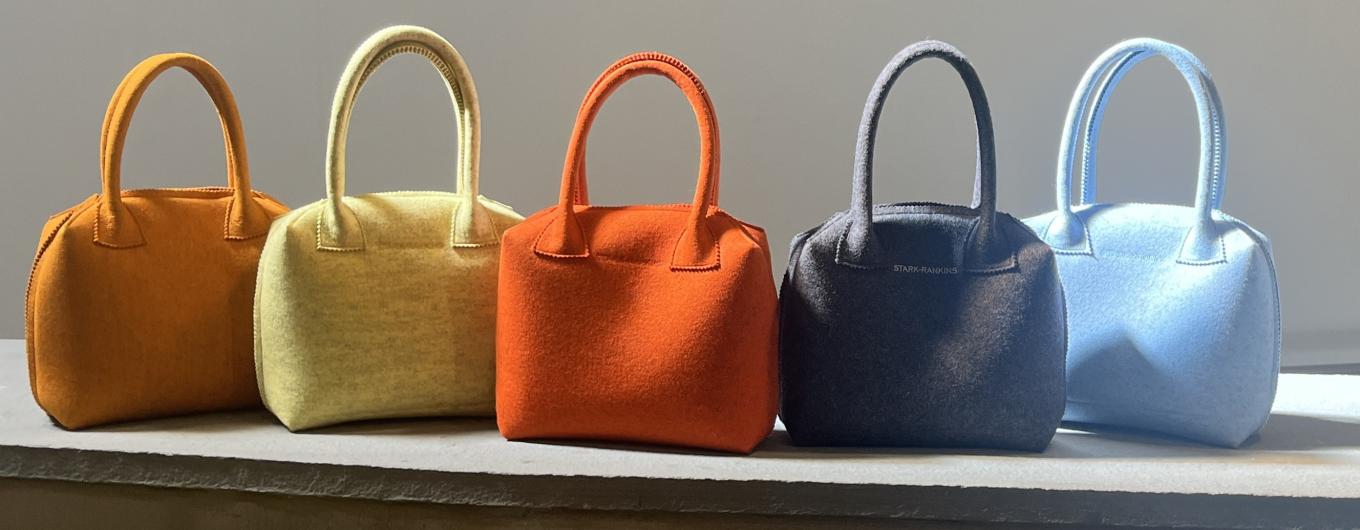 Row of colorful felt purses